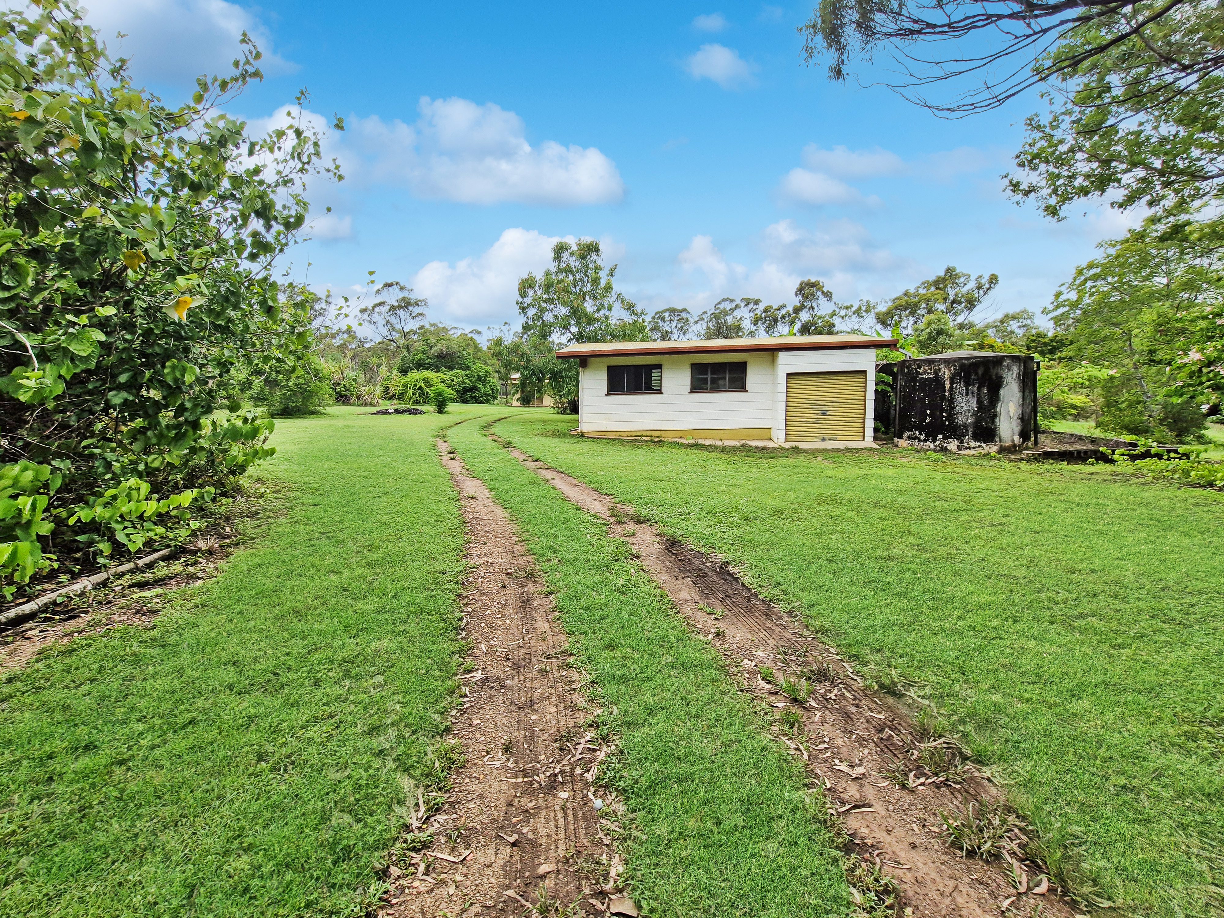 Spacious 5-Acres with Solid Block Home, Income-Generating Studio, and Extensive Sheds & Machinery