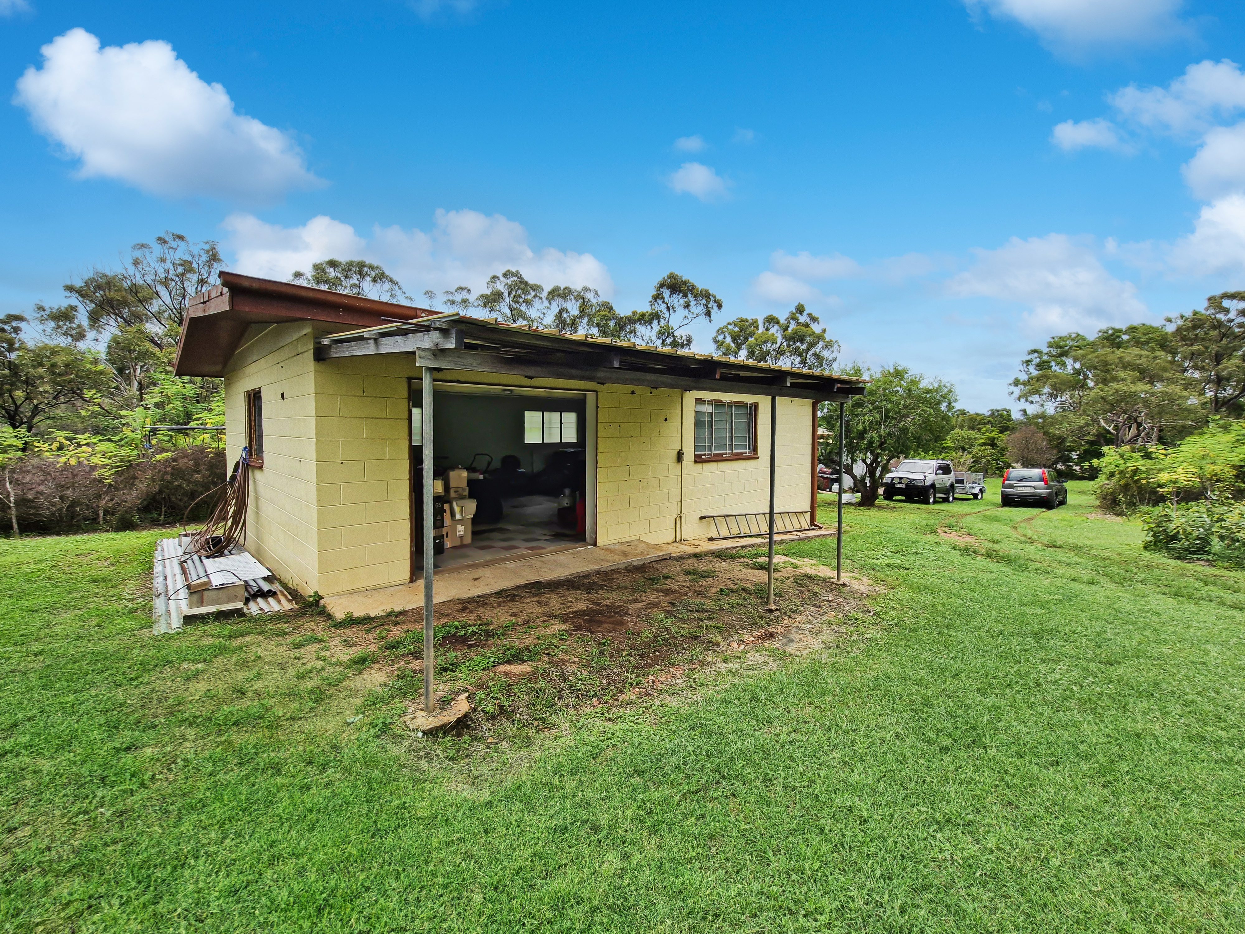 Spacious 5-Acres with Solid Block Home, Income-Generating Studio, and Extensive Sheds & Machinery